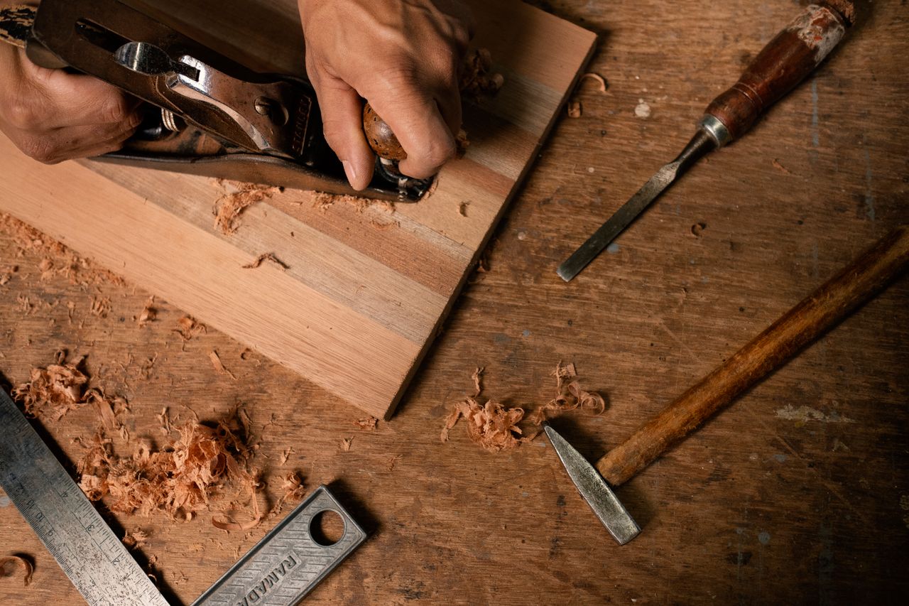 Établi d'ébéniste avec outils et bois massif dans l'atelier
